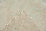 Tightly woven foundation and original side cord selvage of a vintage distressed Oushak rug.
