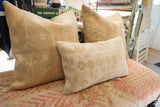 Hand-knotted Turkish rug fragment pillow with subtle beige, blue, and rose motifs.