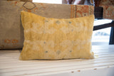 Muted yellow aged texture of antique Chinese rug fragment pillow.