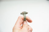 Side profile of a bronze fish ring, showing its green patina and detailed, textured band.