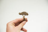 Close view of the vintage African bronze ring with its cast chameleon figure.
