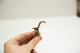 Side profile of the vintage snake ring's cast bronze band and raised head.