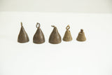 A row of vintage African bronze bells showing slight variations in size and patina.