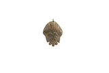 A vintage bronze African pendant showing handcrafted facial features and a time-worn patina.
