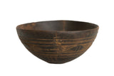 Dark brown vintage African hand-carved wooden bowl, primitive geometric patterns, visible repairs.