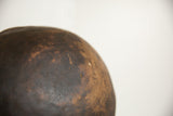 Close-up on the dark, aged patina and textured surface of the wooden African bowl.