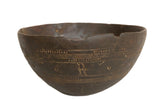 Vintage African wooden bowl, hand-carved with geometric patterns and a rich dark patina.