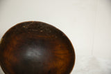 Vintage African wood bowl interior showing dark tones, rich grain, and aged texture.