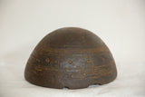 Dark hand-carved wood with primitive etched patterns and aged surface texture.