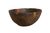 Hand-carved vintage African bowl with a dark rustic finish, incised patterns, and a visible metal repair.