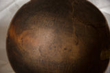 Rich dark patina and aged texture inside a primitive hand-carved wooden bowl.
