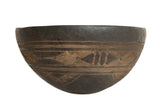 Vintage hand-carved African wooden bowl, dark with lighter geometric patterns.