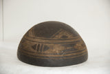 Dark wood vintage African bowl with hand-carved geometric patterns, cracks, and aged patina.