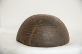 Primitive hand-carved geometric patterns and aged wood texture on an African bowl.