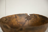 Primitive African wooden bowl detail, showing a crack on the rim with zigzag repair.
