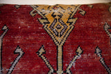 Vintage Oushak rug fragment pillow with ruby red and gold geometric hand-knotted pattern.