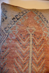 Hand-knotted Oushak rug fragment texture with aged rust, teal, and beige hues.