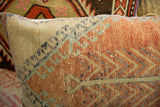Hand-knotted vintage Oushak rug fragment pillow with rust and light green zigzag pattern.