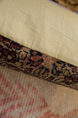 Vintage rug fragment pillow: traditional dark red, blue, brown pattern, and light beige fabric.