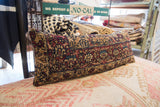 Antique circa 1910s Kerman rug fragment pillow, ornate ruby, sapphire, and tan pattern.