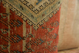 Textured pile of antique Mir Serbend rug fragment pillow in rust, blue-green, and beige.