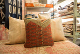 Antique Mir Serbend rug fragment pillow with rust, blue geometric patterns, and woven texture.