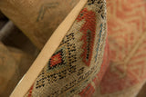Textured side of vintage rug fragment pillow with red, blue, black antique Mir Serbend pattern.