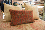Aged red and muted blue geometric pattern on a hand-knotted Mir Serbend rug fragment pillow.