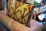 Hand-knotted vintage rug fragment pillow edge, intricate border, and light fabric backing.