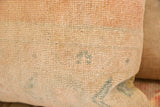Hand-knotted pile of a vintage Oushak rug pillow in time-softened beige and subtle blue motifs.