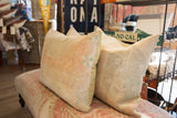 Muted peach, cream, and soft green in a vintage hand-knotted Oushak rug pillow.