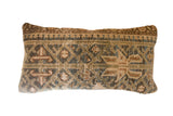 Vintage hand-knotted Persian rug fragment pillow with geometric pattern in muted green, blue, and tan.