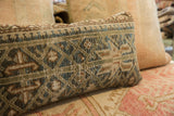 Vintage Persian hand-knotted rug fragment pillow, geometric pattern in teal, sage, brown.