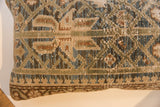 Hand-knotted vintage Persian rug fragment pillow featuring muted geometric patterns in green, blue, and tan.