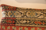 Hand-knotted vintage Mir Serbend rug fragment pillow detail, geometric patterns in red, black, tan.