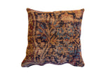 Antique Kerman rug fragment pillow, circa 1910s, with faded tan, blue, and red motifs.