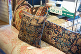 Antique Kerman fragment pillow, traditional floral motifs in dark blue, gold, teal with blue piping.