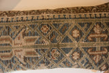 Muted geometric pattern and hand-knotted texture on vintage Persian pillow.