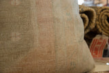 Textured hand-knotted pile of the vintage pillow with soft, faded neutral and muted colors.