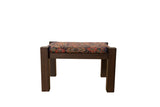 Reclaimed antique rug fragment footstool with a Persian Herati design on a dark wenge wood base.