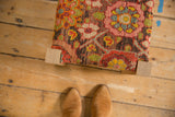Overhead view of the antique Karabagh rug fragment top on a reclaimed oak footstool.