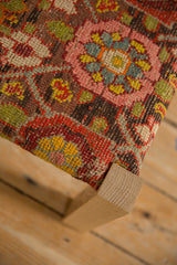 Corner detail of a footstool showing the textured reverse weave of an antique Karabagh rug fragment.