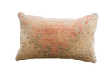 Hand-knotted vintage rug fragment pillow with faded coral and sage floral patterns, 20x12.