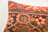 Hand-knotted vintage pillow texture, highlighting ruby red and teal geometric patterns.