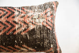 Angled view of the rug fragment pillow corner showing its hand-knotted wool texture.
