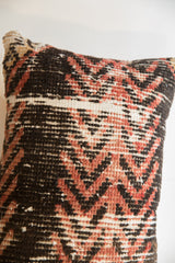 Close-up of the textured weave on the corner of a rug fragment pillow.