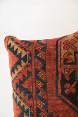 Vintage Rug Fragment Pillow corner, showing textured rust, navy, and gold tribal motifs.
