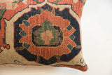Hand-knotted texture of antique Bijar rug pillow, featuring tribal pattern in rust, indigo, beige.