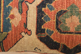 Antique Bijar rug fragment pillow featuring terracotta, indigo, and green hand-knotted motifs.