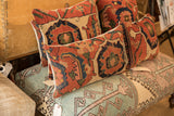 Early 20th century antique Bijar fragment pillows, rich geometric patterns, orange-red and navy.